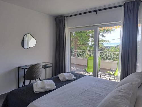 a bedroom with a bed and a view of a balcony at Apartments No26 in Povile