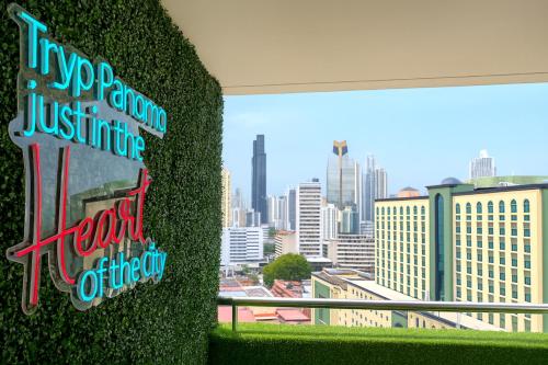 a green wall with a view of a city at Tryp by Wyndham Panama Centro in Panama City