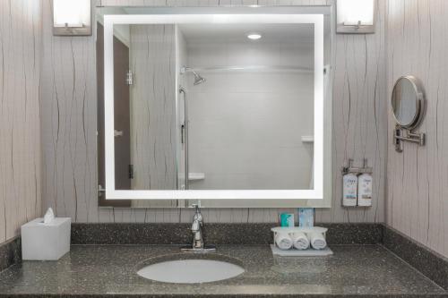 a bathroom with a sink with a large mirror at Holiday Inn Express & Suites Cold Lake by IHG in Cold Lake