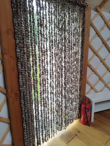 a large rug hanging on the wall of a room at Le camélia in Brugelette