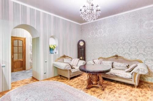 a living room with a couch and a table at Апартаменты на Дерибасовской in Odesa