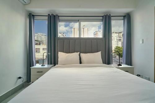 Ένα ή περισσότερα κρεβάτια σε δωμάτιο στο New! Modern City Escape 1Br In Heart Of Santo Domingo
