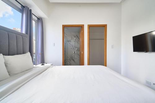 Ένα ή περισσότερα κρεβάτια σε δωμάτιο στο New! Modern City Escape 1Br In Heart Of Santo Domingo