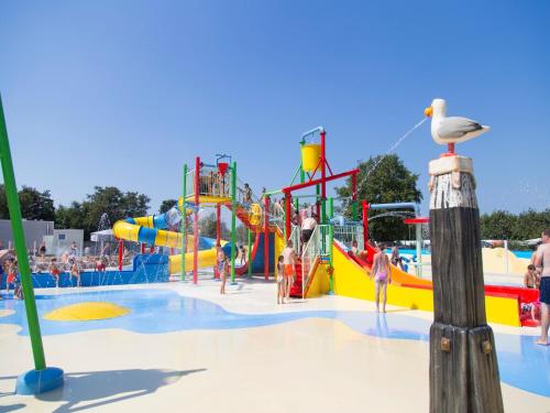 a large water park with people playing in it at Villa in Burgh-Haamstede with Garden in Burgh Haamstede