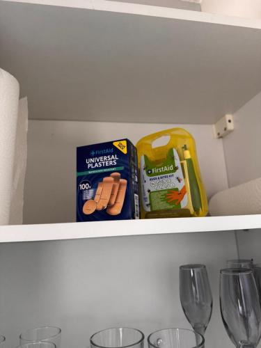 a shelf with some snacks and wine glasses at appartement 2 pièces in Saint Lo