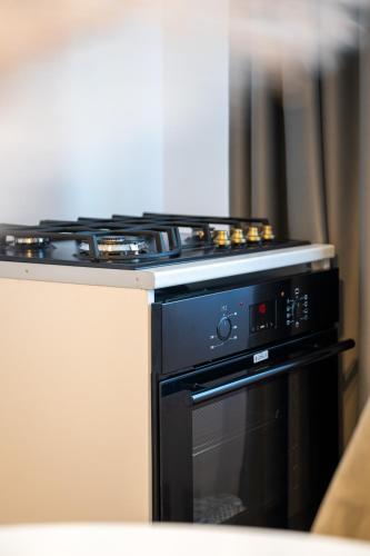 a black stove top oven sitting in a kitchen at Apartament de închiriat Accommodation in Suceava
