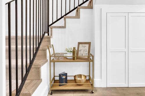 a stairway with a console table next to a staircase at The Park Street Hideaway in Downtown Paso in Paso Robles
