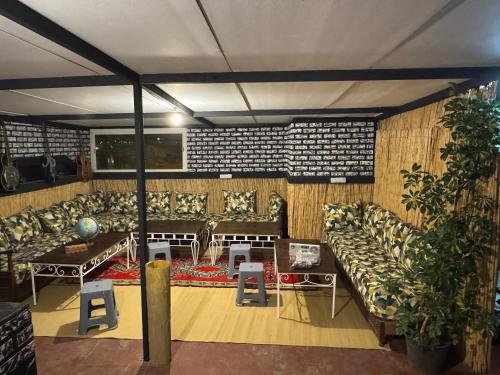a living room with couches and a table and chairs at Essaouira trip hostel in Essaouira
