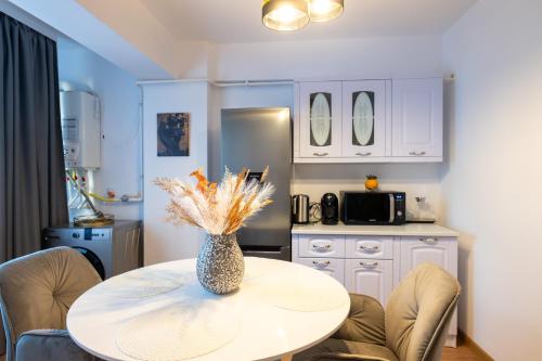 a kitchen with a table with a vase on it at Apartament de închiriat Accommodation in Suceava