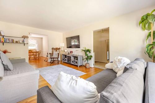 a living room with a couch and a table at 3BR Home - Free Parking-WiFi Kitchen Laundry-Kids Friendly-Near DC & Downtown & Metro-Patio & Deck in Falls Church