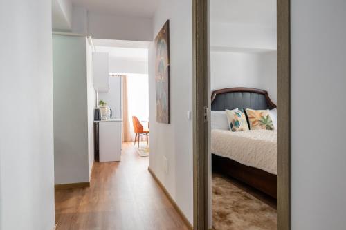 a bedroom with a bed and a mirror at Apartament de închiriat Accommodation in Suceava