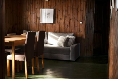 a living room with a couch and a dining room table at Tündér Farm in Zirc