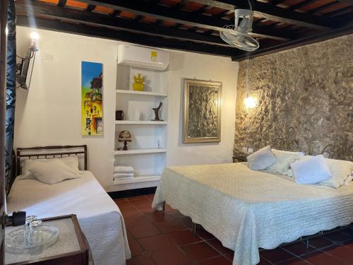 a bedroom with two beds in a room at Hotel Casa de Las Palmas in Cartagena de Indias