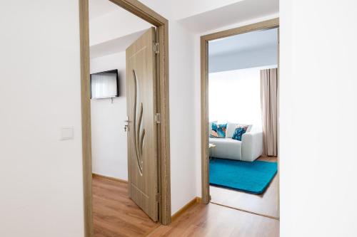 a hallway with a mirror and a living room at Apartament de închiriat Accommodation in Suceava