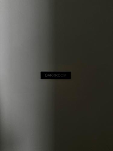 a black sign that says dark room on a wall at La DARKROOM in Ploërmel