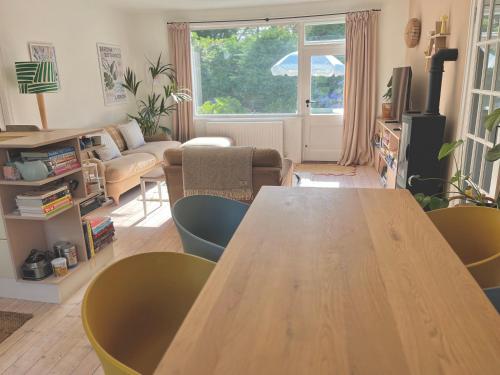 a living room with a wooden table and chairs at The Shades - Bliss In The Heart of Windermere in Windermere