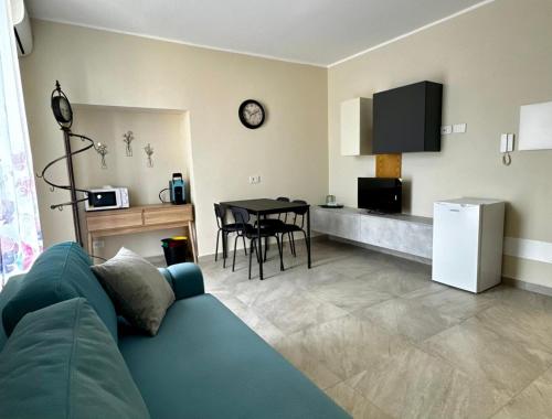 a living room with a blue couch and a table at Villa Patrizia affittacamere con parcheggio privato in Como