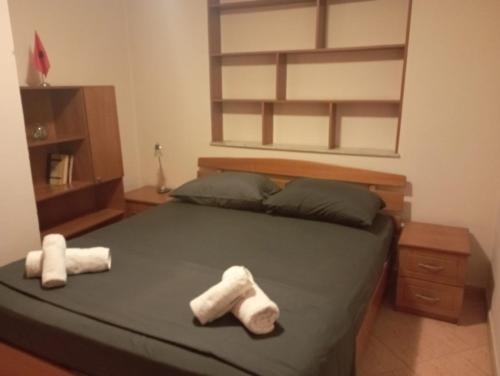 Un dormitorio con una cama con dos toallas encima. en E&B Cosy Apartment 4, en Tirana