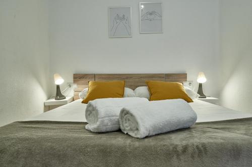 a bedroom with a large bed with two pillows at NUEVO Apartamento Centro Lleida in Lleida