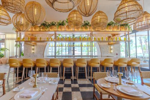 a dining room with tables and chairs and chandeliers at Unico Hotel Riviera Nayarit - Adults Only - All Inclusive in Nuevo Vallarta 