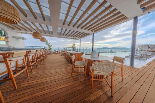 a restaurant with tables and chairs and a view of the water at Unico Hotel Riviera Nayarit - Adults Only - All Inclusive in Nuevo Vallarta 