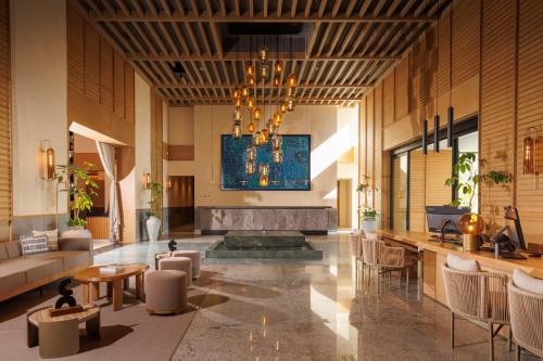 a lobby with a couch and a chandelier at Unico Hotel Riviera Nayarit - Adults Only - All Inclusive in Nuevo Vallarta 