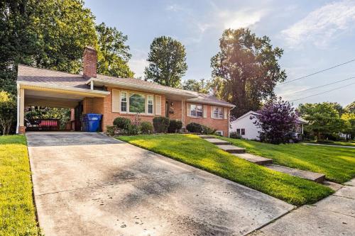 a home with a driveway and grass at 3BR Home - Free Parking-WiFi Kitchen Laundry-Kids Friendly-Near DC & Downtown & Metro-Patio & Deck in Falls Church