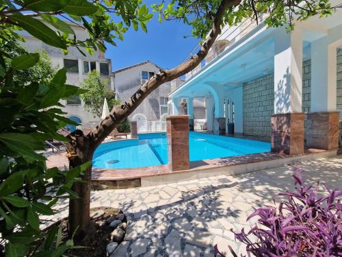 a swimming pool in the backyard of a house at Villa Golf 2 in Budva