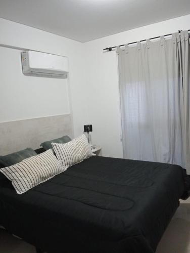 En eller flere senge i et værelse på Depto Centrico Etoile 4