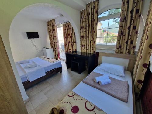 a hotel room with two beds and a window at Villa Golf 2 in Budva
