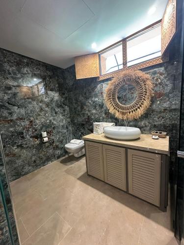 a bathroom with a sink and a toilet at Hôtel Jardins de lina et lea in Marrakesh