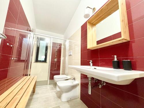 a bathroom with a sink and a toilet at La Casa del Riccio in Tindari