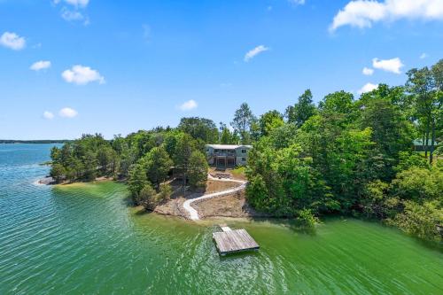 an aerial view of a house on an island in the water at Rustic Lakefront Home with Beach in Sevierville