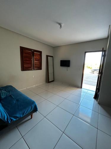 a room with a bed and a television in it at Casa na entrada de Tutoia MA in Tutóia