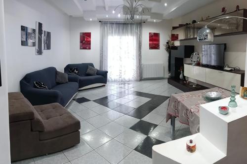 a living room with two couches and a television at Appartamento vista mare in Castellammare del Golfo