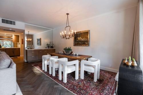a dining room with a table and white chairs at Talisman Condos by Vail Realty in Vail
