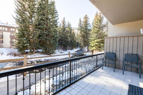 two chairs on a balcony with snow on the ground at Talisman Condos by Vail Realty in Vail