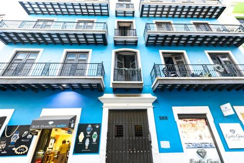 a blue building with windows and balconies at Old San Juan The Core By Otium in San Juan