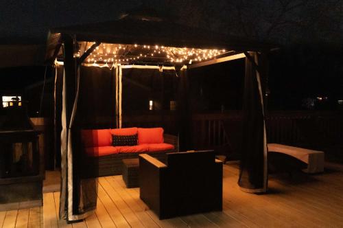 a couch under a gazebo with lights on it at Mason Marvel Luxe Stay with Pool and Hot Tub in Mason