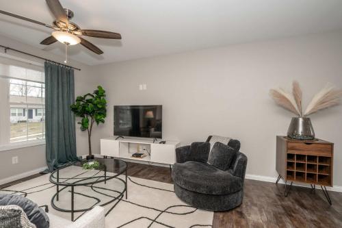 a living room with a chair and a tv at The Gem Vacation Rental in Walton