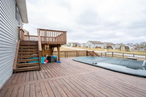 a deck with a wooden staircase and a swimming pool at The Gem Vacation Rental in Walton