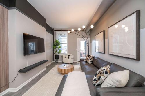 a living room with a couch and a table at Queen City Views 3 Chic 2 BDR in Cincinnati