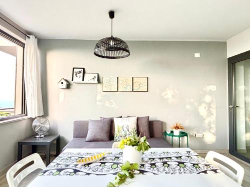 a living room with a table and a couch at La Casa del Riccio in Tindari