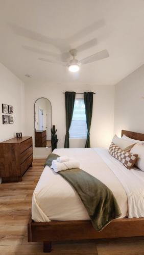 a bedroom with a large bed and a mirror at Cozy 1BR Tiny Home near Downtown and NB Rivers in New Braunfels