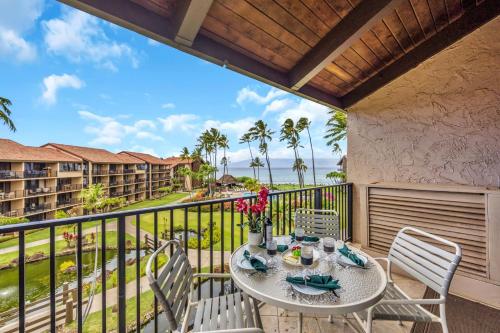 a patio with a table and chairs on a balcony at Papakea C405 in Kahana