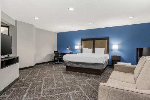 a hotel room with a bed and a flat screen tv at Best Western Rochester Hotel Mayo Clinic Area/ St. Mary's in Rochester