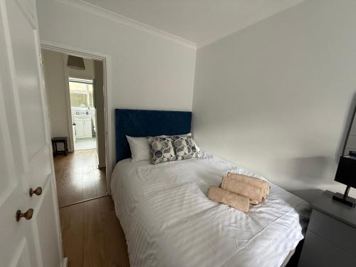 a bedroom with a bed with two towels on it at Self-catering Apartment in the Heart of London Victoria in London