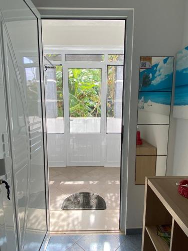a bathroom with a shower with a window at A casa da Xã in Almagreira