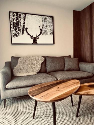 a living room with a couch and a table at les colibris in Passy