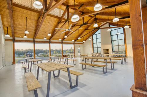 a cafeteria with wooden tables and benches and windows at Savannah Lakes RV Resort in Hardeeville